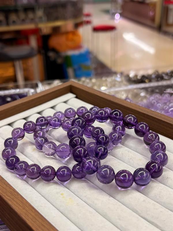 Amethyst bracelets laid out in a workshop display tray
