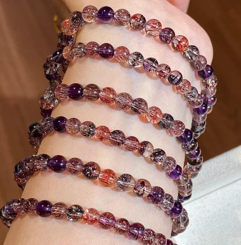 Super seven bracelets showing violet, red and black inclusions